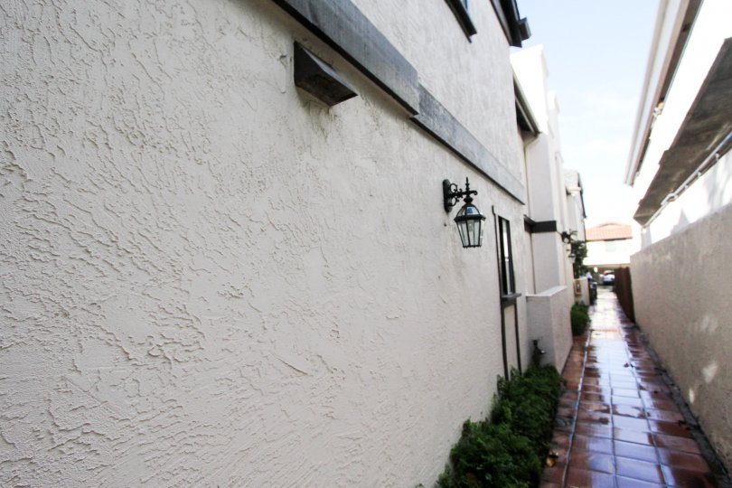 Wet walkway between two residential buildings at Crown Manor in Coronado California