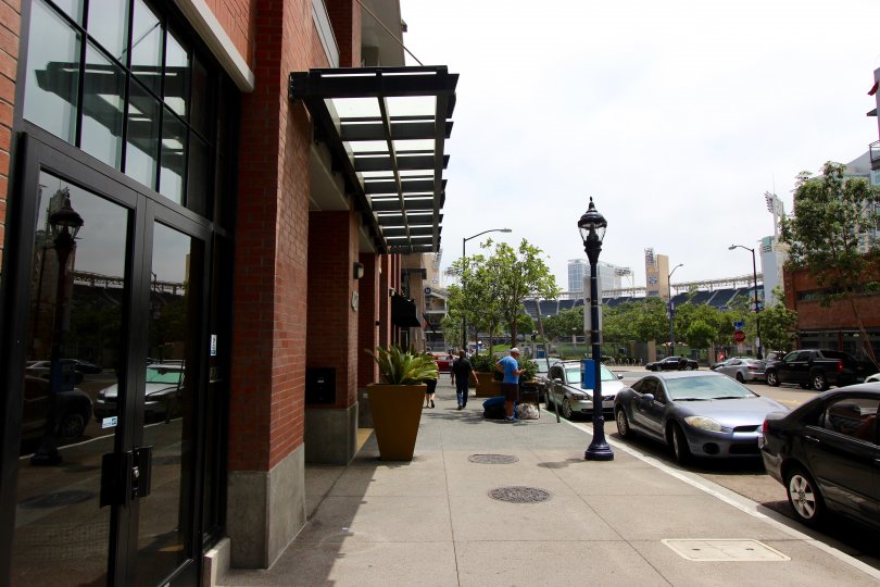Sidewalk in front of a tall brick building at Diamond Terrace CA