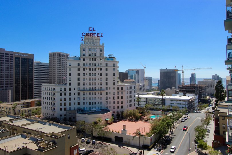 The large facade of the El Cortez hotel looms around its neat gardens and wide streets in downtown San Diego, CA