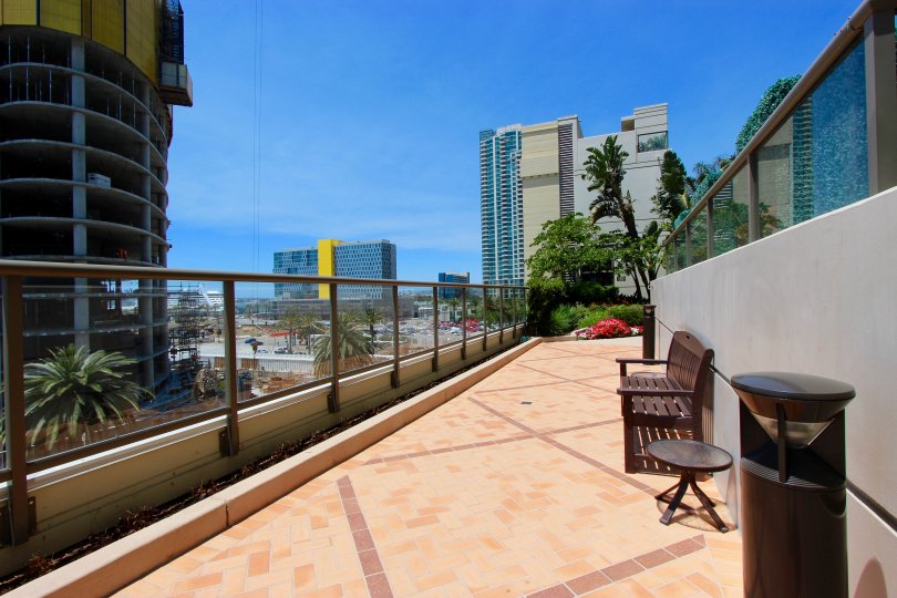 Sunny Balcony view with seating overlooking downtown San Diego, with seating and flowers.