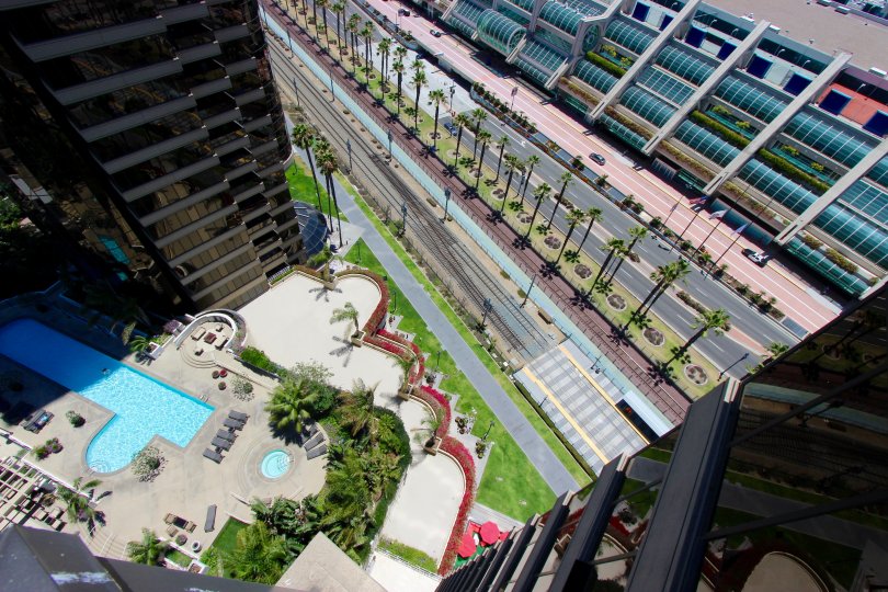 A sunny and radiant day at The Harbor Club with views of the the glistening swimming pool and the gorgeous roadways lined with palm trees.