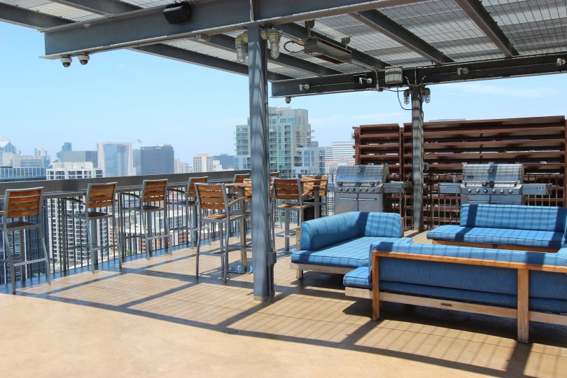 This shows the top floor of the resort which has the lot of chairs and the tables and views the neighbouring buildings in the Icon community