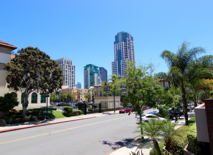 A few cars are parked on the street in front of Marina Park condos