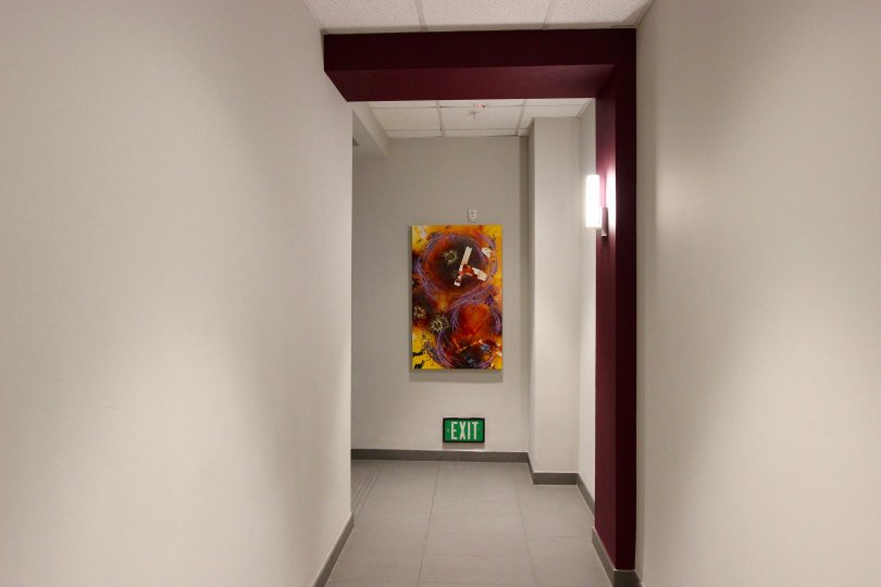 A green exit sign sits low to the ground at Nexus condos