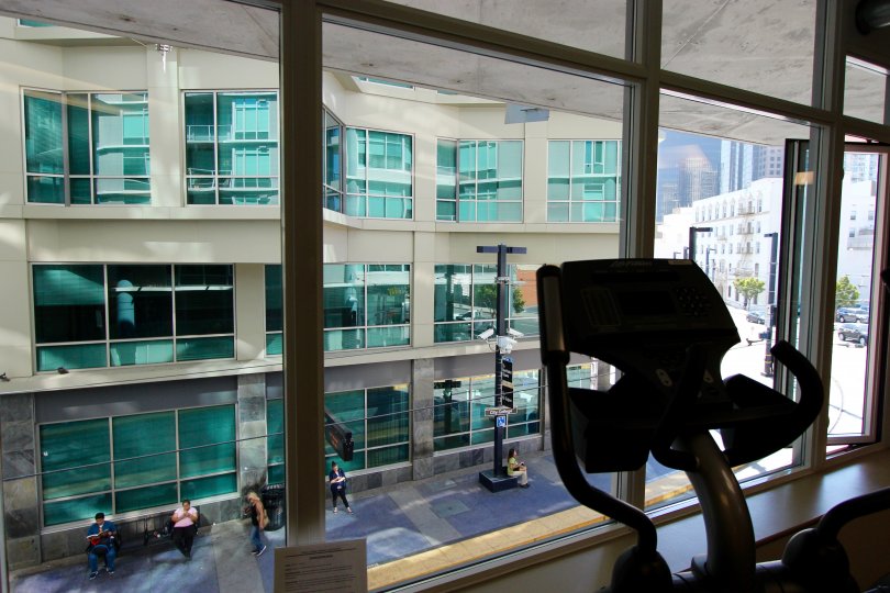 A sunny day in the area of Smart Corner, workout room, eliptical machine, people, outside, windows