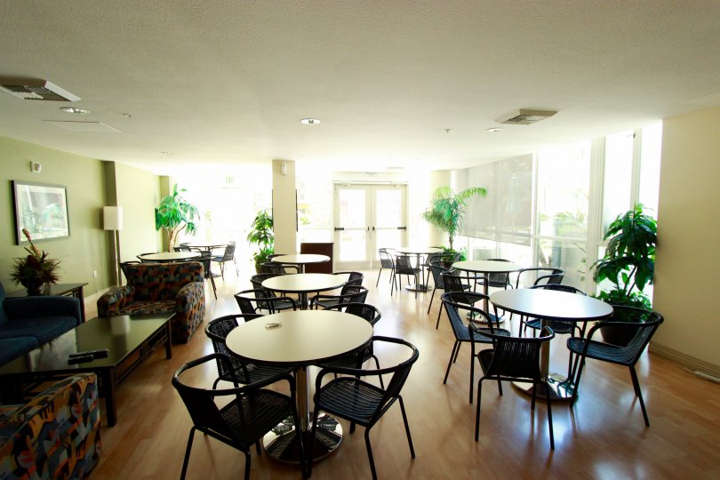 Inside of a building with lots of tables in chairs in TREO