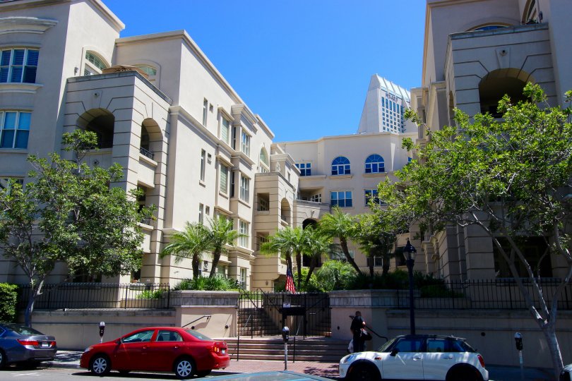 Cars parked on the street by a garden in front of Watermark in downtown San Diego, CA
