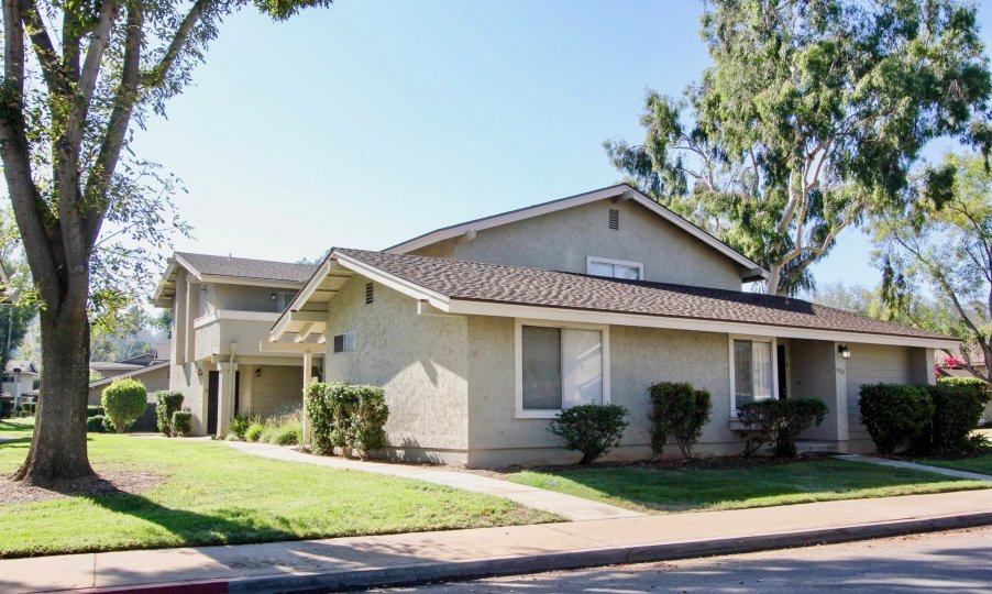 Front and side view of a beautiful home and green yard in the Jamacha Greens communty of El Cajon, California