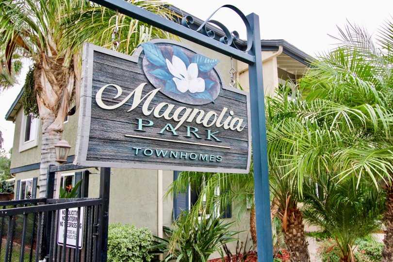 A sign indicating the Magnolia Park Townhomes, a residential community located in El Cajon, CA