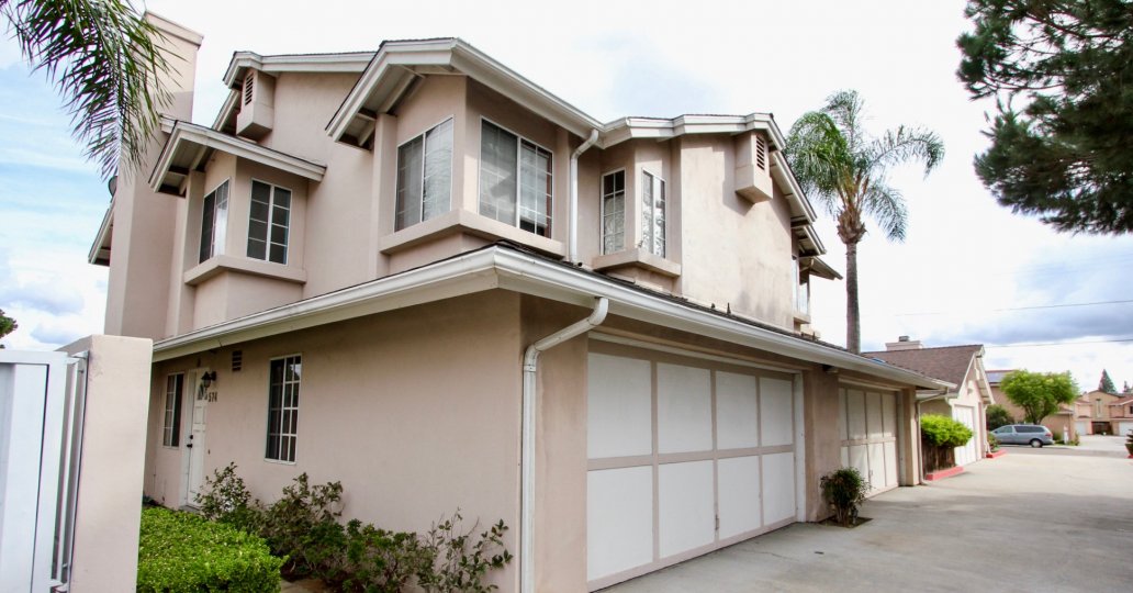 VERY BEAUTIFUL HOUSE. IN FRONT OF IT THERE ARE SMALL TREES. AND THERE IS A ROAD, VERY CLEAN.