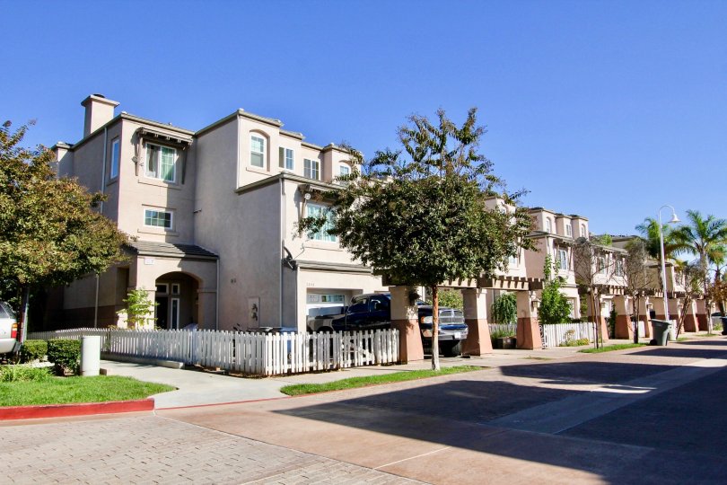 Street view of the building decorated with plants and trees with care parking in Escondido Park Row
