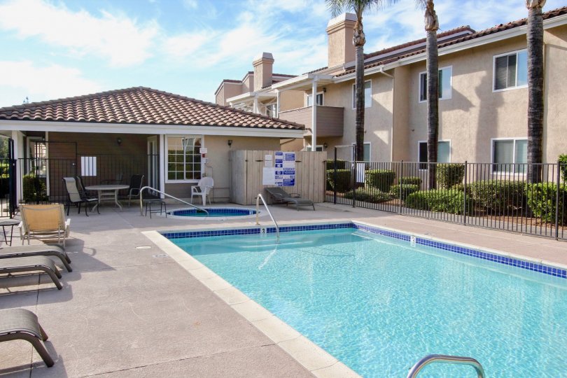 Swimming pool and sunning area near housing units at Mountain View Villas in Escondido California