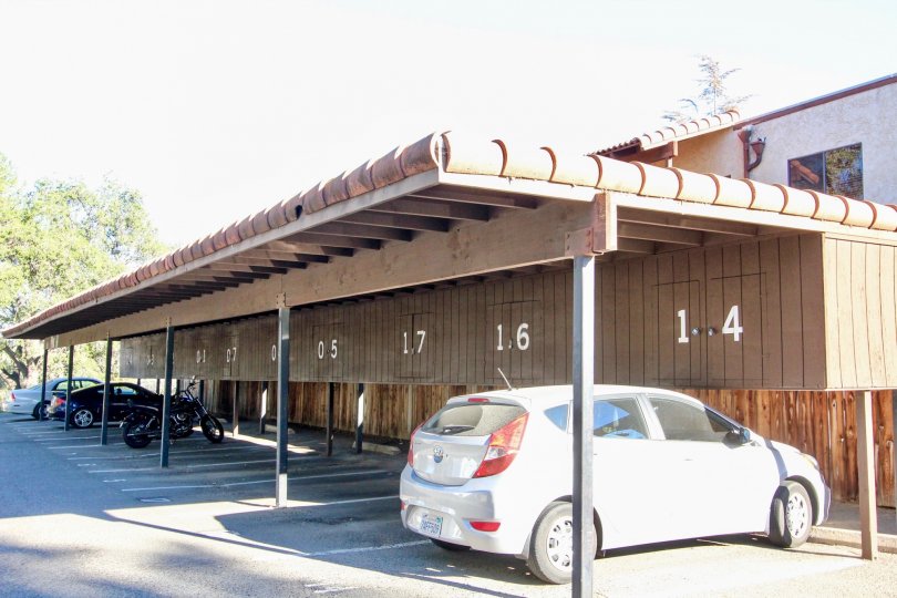 white hatchback is parked under a carport at Vista Del Mundo condos