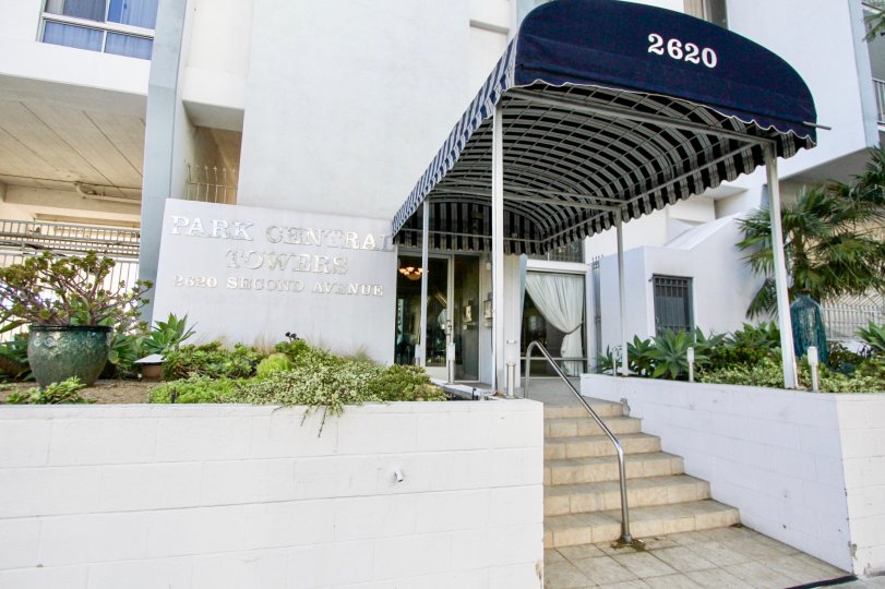 An entrance of a building in the Park Central Towers with beautiful plants.