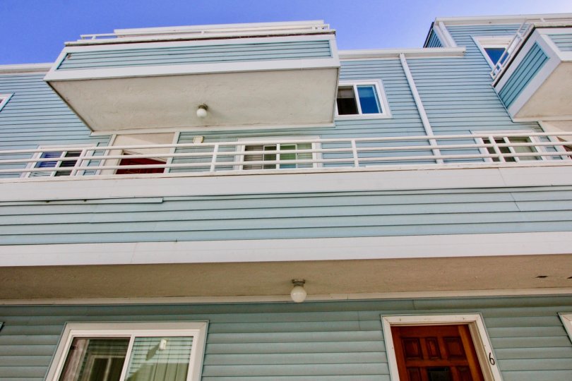 A sunny day in Coastwalk Townhomes has villa door with number 6