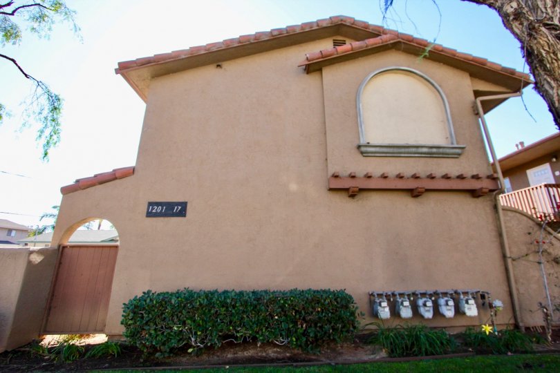 On Donax, There is a house in front view with grass and flowers.