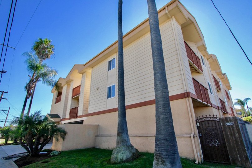 Three story residential units with security fence at Playa Dahlia in Imperial Beach California