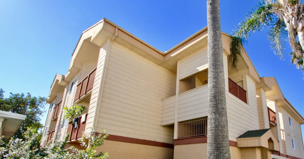 Three story town homes with brown railings at Playa Dahlia in Imperial Beach CA