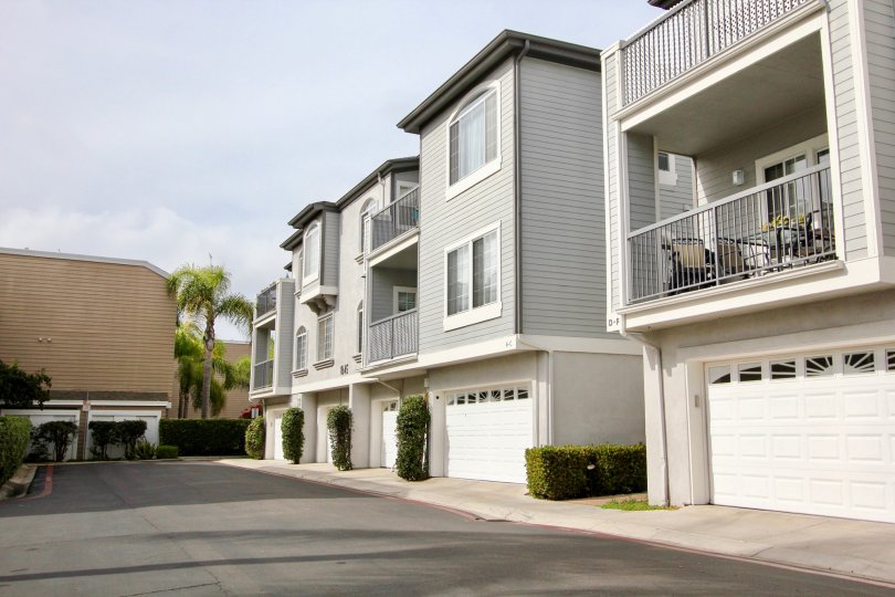 Gray residential units with white garage doors at Cape La Jolla Gardens in La Jolla California