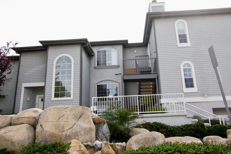 Two story gray home with stone water fall at Cape La Jolla Gardens in La Jolla CA