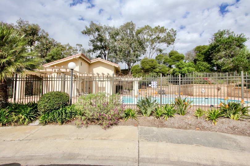 Metal fence around a pool with potted plants in El Dorado at La Jolla California