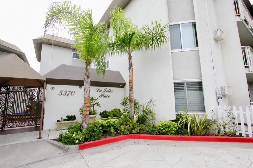 Red curb near gray condo homes inside La Jolla Place in La Jolla CA