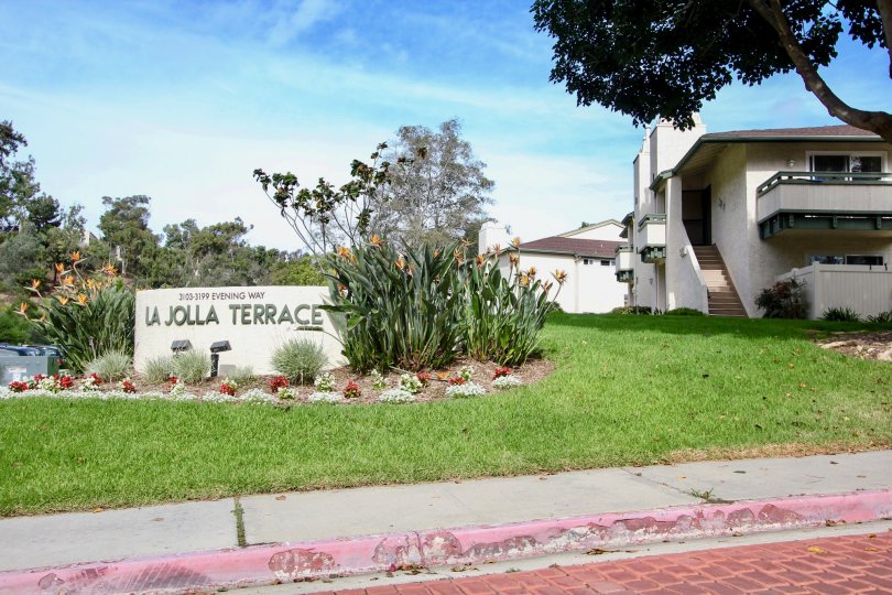 la jolla terrace entrance stone with beautiful grass and floral arrangment