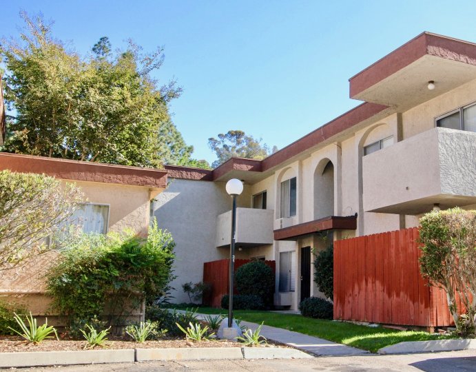 A two-storey residence in the Carroll Canyon Gardens community painted in cream and red.