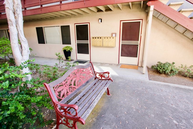 Frontage of The Pointe at Mission Hills has bench and postal box is attached near the door