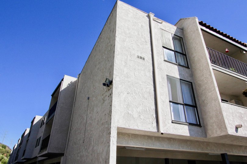 Three story gray units with parking inside Teh Franciscan at Mission Valley CA