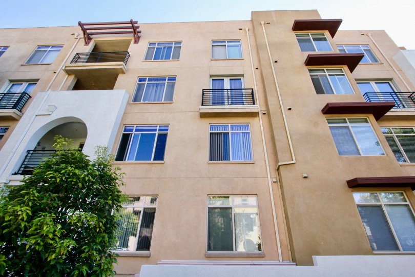 The Lido community in Mission Valley, California; a four story residential community with stucco walls and blue sky.