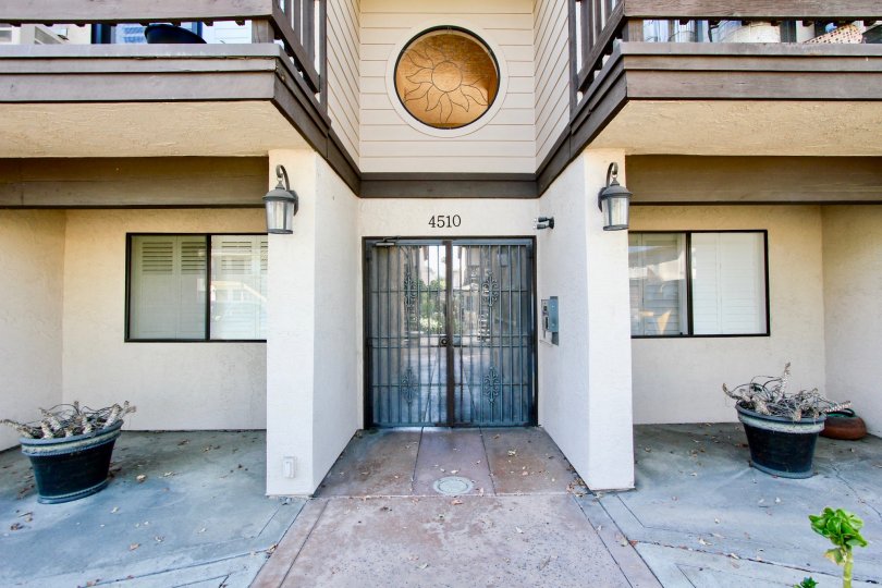 A sunny day in the area of Garden Heights, doorway, potted plants, balcony, buzzer