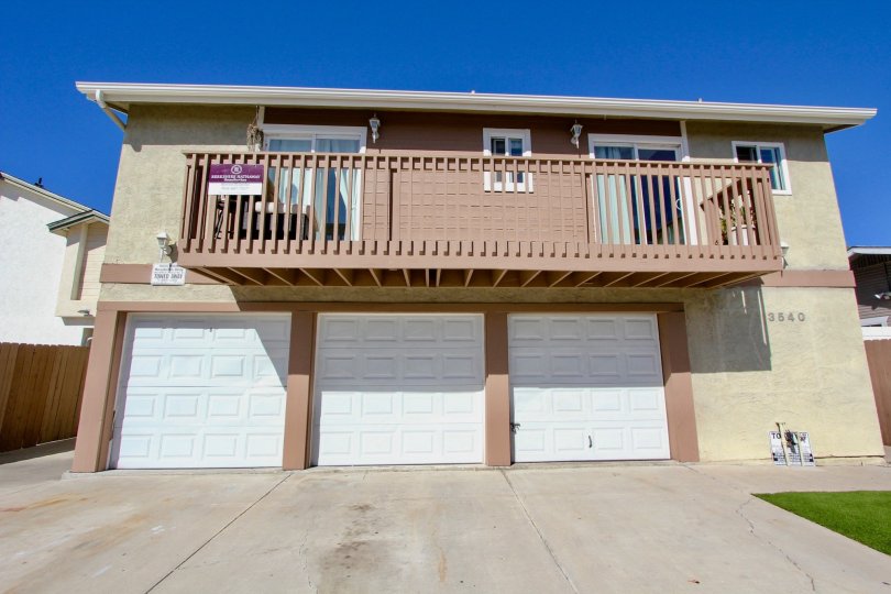 A balcony and garage doors on a home at Madison Gardens in Normal Heights California.