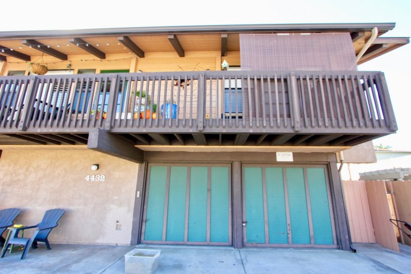 A house in Magnolia Manor with a double garage and upstairs wooden balcony.