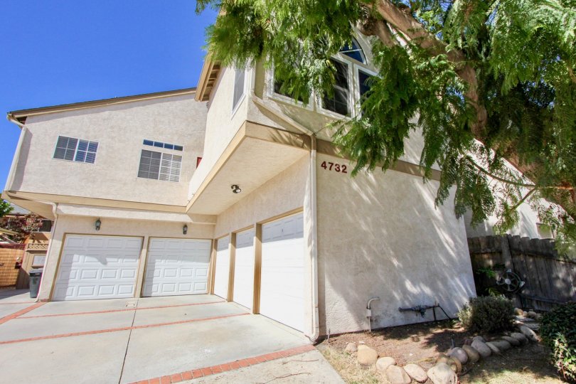 A sunny wide-angle view of the front of one unit at Marko 34th in Normal Heights