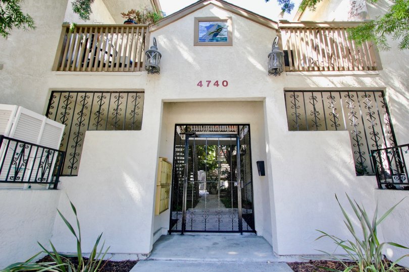 A black iron security door in front of the Normal Heights Villas at Normal Heights CA