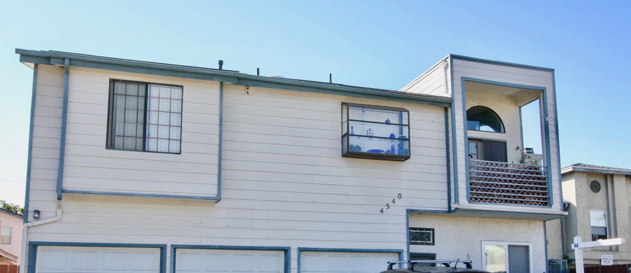 A sunny day in the area of North Court, balcony, windows, roof, garages, sign