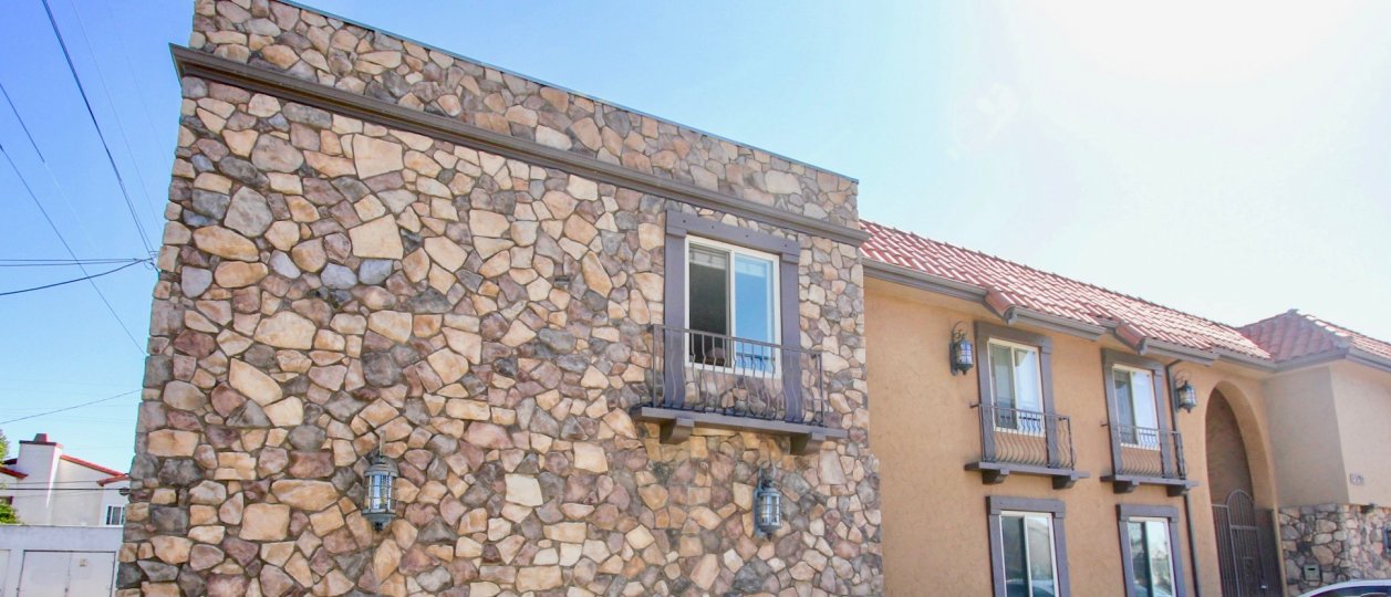 A front view of a stone tiled orange house on 34th in Normal Heights.