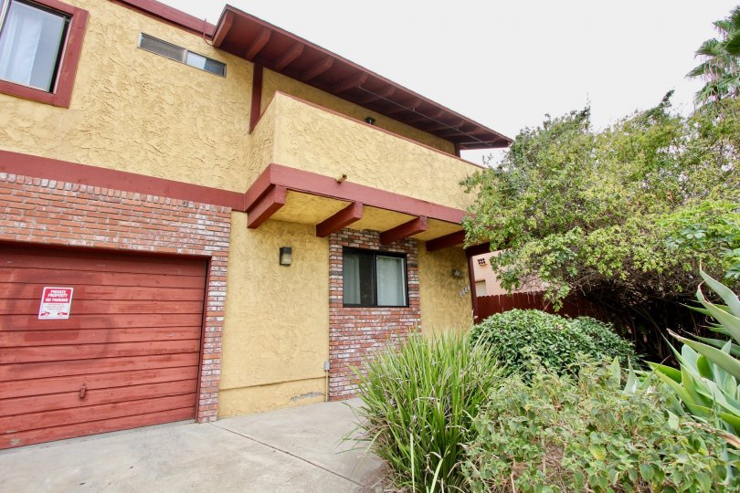 Red wood garage door with red bricks inside Hamilton Chateau in North Park CA
