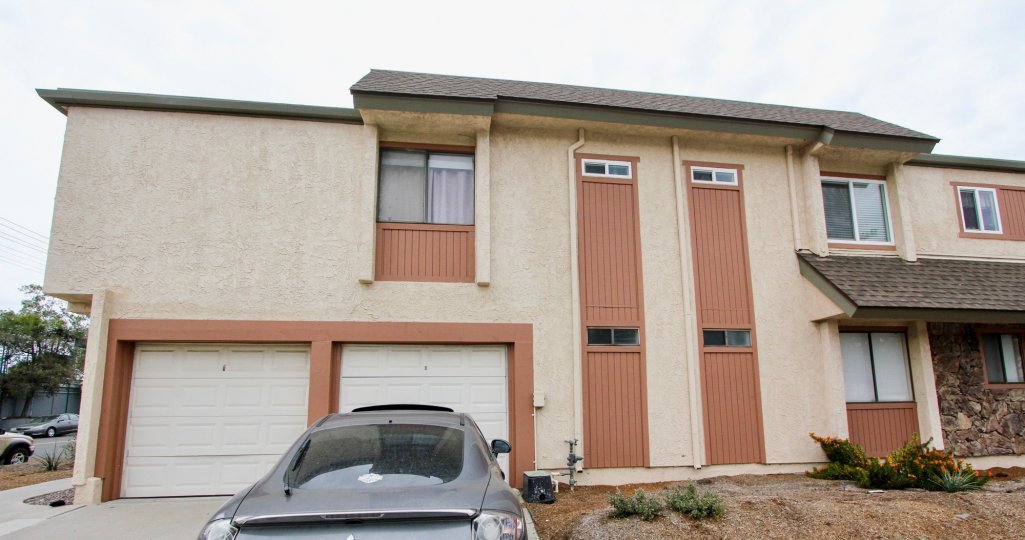 A front view of the garage and stucco sided house in Idaho Villas