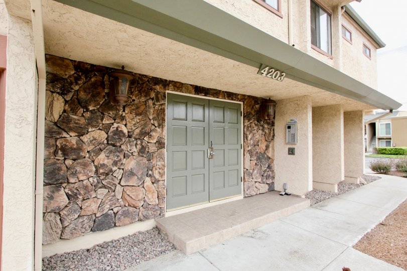 Front of a house with big main door and two levels in the Idaho Villas