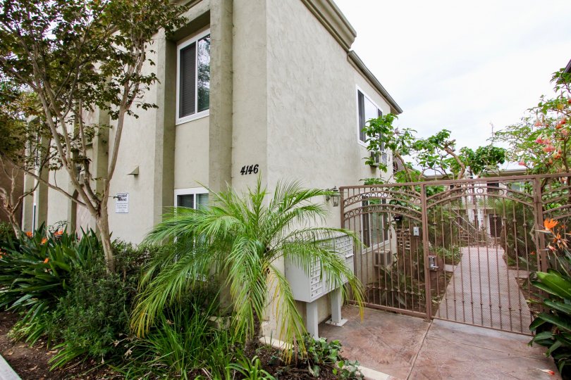 A beautiful California Building on a sunny day with a fence and trees