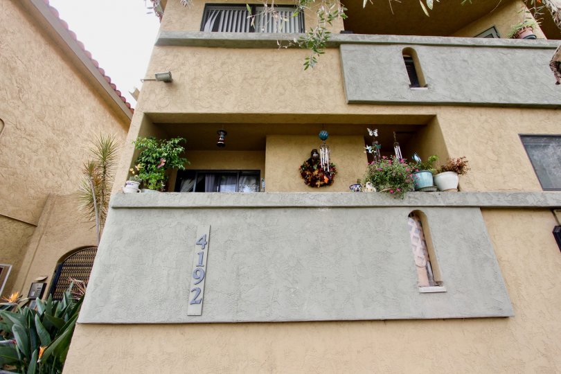 A three storey apartment with a balcony on every floor in the Spanish Oaks I community in North Park, California