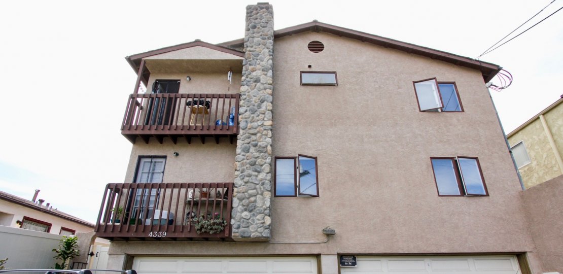 A house with balconies and a brick chimney in Tangerine Tree neighborhood