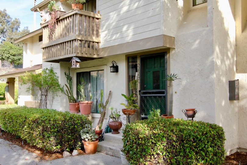 Two story homes with dark green doors inside El Camino Club Estates at Oceanside California