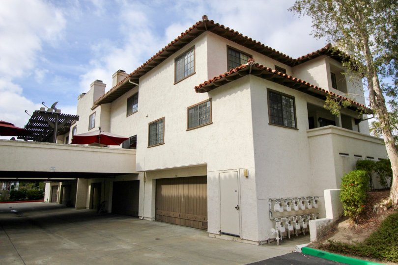Spanish style Mission Point townhome residence with garage door and overhang in Oceanside California