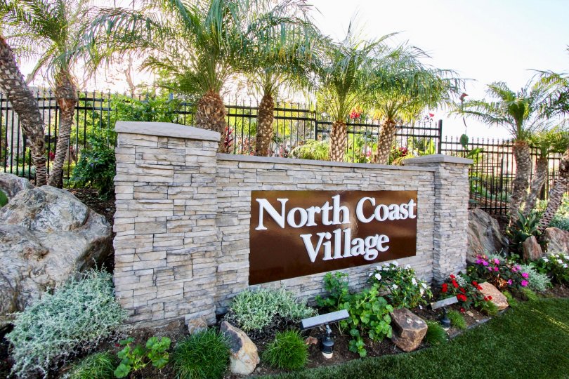 Colorful plantation at the name board and rocks in North Coast Village.