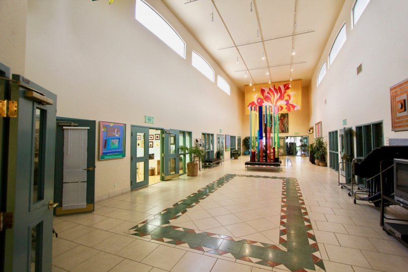 A lobby with shrubbery and art at Ocean Hills Country Club in Oceanside, CA