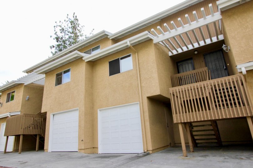 Beige and white trimmed walls with attached garages located at the Quail Ridge.