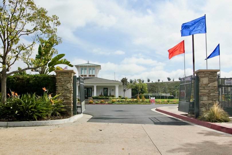 front entrance decorated with flag, trees and plants with flowers in St Cloud at Ocean Ranch